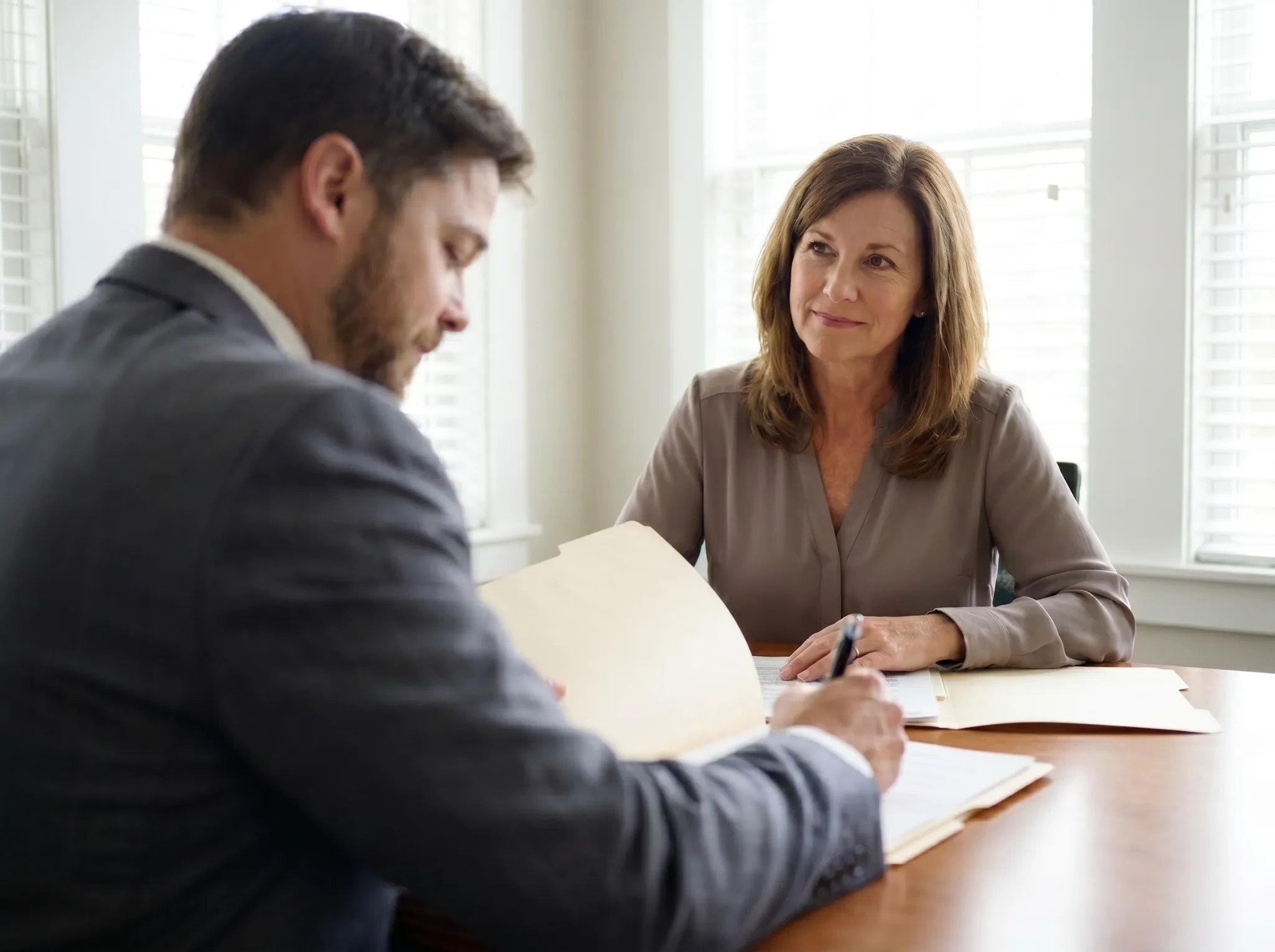 Attorney reviewing claim documents with a client